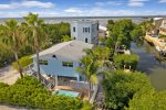 Aerial views of the home, street, canal and pool: PELICANS NEST